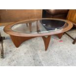 AN OVAL RETRO G-PLAN STYLE TEAK COFFEE TABLE WITH GLASS INSET TOP