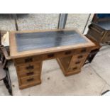 AN EDWARDIAN OAK TWIN-PEDESTAL DESK WITH INSET LEATHER TOP, 48x23"