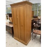 AN OAK WARDROBE WITH TWO DOORS