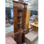 AN ITALIAN STYLE CORNER CUPBOARD WITH GLAZED AND BOWFRONTED UPPER PORTION