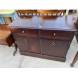 A STAG MINSTREL SIDEBOARD ENCLOSING TWO DRAWERS AND TWO CUPBOARDS, 38" WIDE