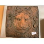 A TERRACOTTA LION TILE PLAQUE