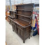 AN ERCOL ELM DRESSER WITH TWO DOORS, TWO DRAWERS AND UPPER PLATE RACK