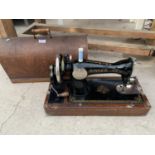 A CASED VINTAGE SINGER SEWING MACHINE WITH KEY