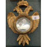 A SMALL WOODEN MIRROR IN THE SHAPE OF AN EAGLE