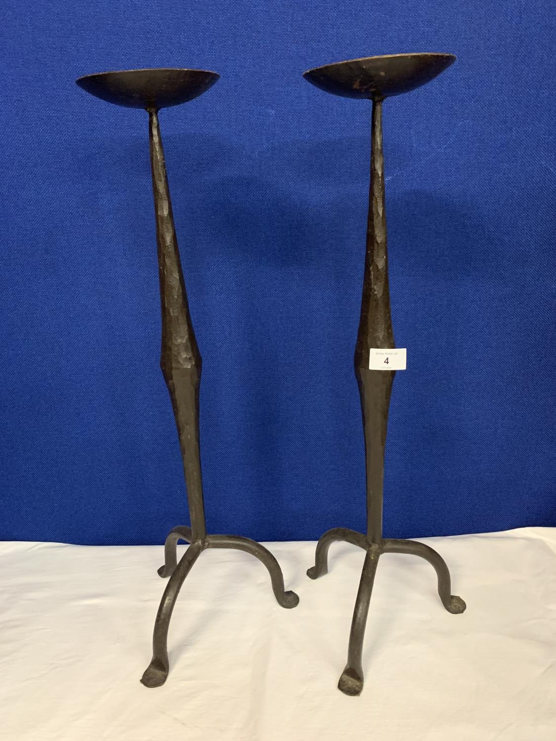 A PAIR OF TALL WROUGHT IRON CANDLESTICKS