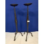 A PAIR OF TALL WROUGHT IRON CANDLESTICKS