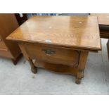 A MODERN OAK COFFEE TABLE WITH SWIVEL TOP AND SLIDE OUT SHELF