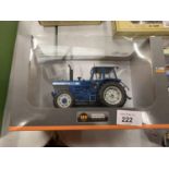 A BOXED UNIVERSAL HOBBIES DIE CAST FORD TRACTOR 1:32