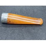 A BELIEVED AMBER AND SILVER TIPPED CIGAR HOLDER