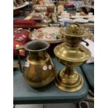 A LARGE BRASS JUG AND A BRASS OIL LAMP BASE