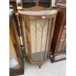 A BOW FRONT MAHOGANY CHINA CABINET ON CABRIOLE SUPPORTS WITH GLAZED PANEL DOOR