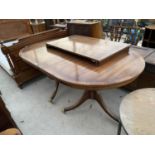 A MAHOGANY EXTENDING DINING TABLE ON TWIN PEDESTAL SUPPORTS