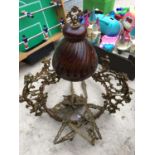 A VINTAGE CEILING LIGHT WITH ORNATE BRASS DETAILING AND CERAMIC CENTRE PIECE
