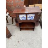 A SMALL WALL MOUNTED MAHOGANY CABINET WITH SIDE SHELVES AMD SINGLE DOOR WITH DELFT TILE PANELS