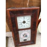 A WALL MOUNTED WOODEN BOXED CLOCK WITH ORNATE GLASS FRONT