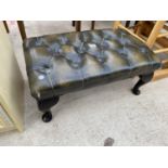 A LEATHER CHESTERFIELD STYLE BUTTONED FOOTSTOOL ON CABRIOLE SUPPORTS