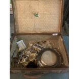 A SMALL VINTAGE SUITCASE CONTAINING AN ASSORTMENT OF COSTUME JEWELLERY