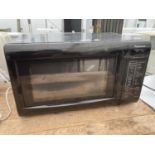 A BLACK PANASONIC MICROWAVE BELIEVED IN WORKING ORDER BUT NO WARRANTY