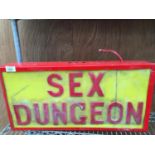 A SEX DUNGEON ILLUMINATED SIGN