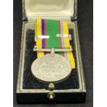 A BOXED WWII DEFENCE MEDAL AND BAR ENGRAVED EYGPT