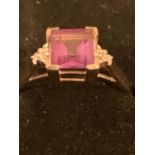 A 9 CARAT GOLD PURPLE STONE AND DIAMOND RING