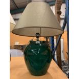A VERY LARGE MODERN BOTTLE GREEN TABLE LAMP TO INCLUDE AN OLIVE GREEN TRIMMED SHADE
