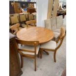 A MODERN CIRCULAR EXTENDING DINING TABLE AND FOUR CHAIRS, 41" DIAMETER