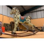 AN ANTIQUE METAL ROCKING HORSE