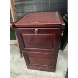 A WOODEN TWO DRAWER FILING CABINET