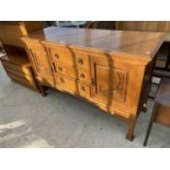 AN ART NOUVEAU OAK SIDEBOARD, 60" WIDE, ENCLOSING THREE DRAWERS AND TWO CUPBOARDS