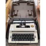 A SMITH-CORONA TYPE WRITER IN A CARRY CASE