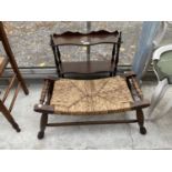 A RUSH SEATED STOOL WITH TURNED CARRYING HANDLES AND MAHOGANY THREE TIER WASH SHELF