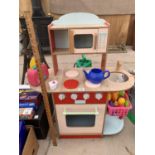 A CHILDREN'S WOODEN PLAY KITCHEN