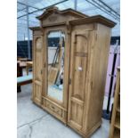 A VICTORIAN PINE THREE DOOR WARDROBE WITH CENTRAL MIRROR DOOR, 73 INCHES WIDE