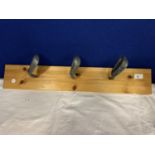 A WOODEN COAT RACK UTILISING GOLF CLUBS AS THE HOOKS