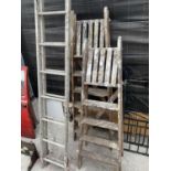 AN ALLOY LADDER AND TWO VINTAGE WOODEN STEP LADDERS