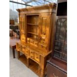 A MODERN PINE DRESSER COMPLETE WITH PLATE RACK, THE BASE ENCLOSING SEVEN DRAWERS AND POT BOARD,