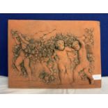 A TERRACOTTA CHERUBS TILE PLAQUE