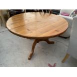 A CIRCULAR PINE DINING TABLE ON TRIPOD SUPPORT