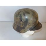 A CAMOUFLAGE PAINTED GERMAN HELMET WITH SS DECAL, LEATHER LINING
