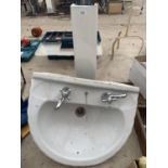 A BATHROOM PEDESTAL AND SINK