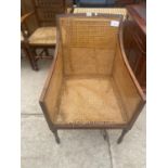 A 19TH CENTURY STYLE BERGERE MAHOGANY FIRESIDE CHAIR ON TURNED FRONT LEGS