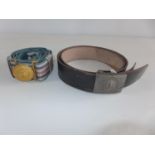 A GERMAN BLACK LEATHER BELT WITH NAZI WERMACHT BELT BUCKLE AND A FURTHER BELT WITH GILT METAL BUCKLE