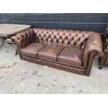 A BROWN LEATHER CHESTERFIELD THREE SEATER SETTEE