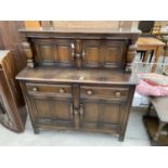 AN ERCOL COURT CUPBOARD ENCLOSING CUPBOARDS AND DRAWERS, 48" WIDE