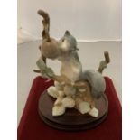A LLADRO ORNAMENT OF A SQUIRREL ON A WOODEN BASE