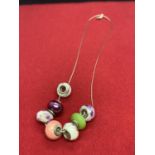 SEVEN PANDORA STYLE BEADS ON A SILVER NECKLACE