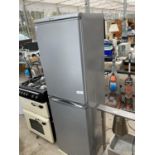 AN UPRIGHT SILVER HOTPOINT FRIDGE FREEZER BELIEVED IN WORKING ORDER BUT NO WARRANTY