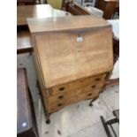 A SMALL MAHOGANY BUREAU ON CABRIOLE SUPPORTS WITH FALL FRONT AND THREE DRAWERS